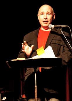 man speaking at podium tom oconnor